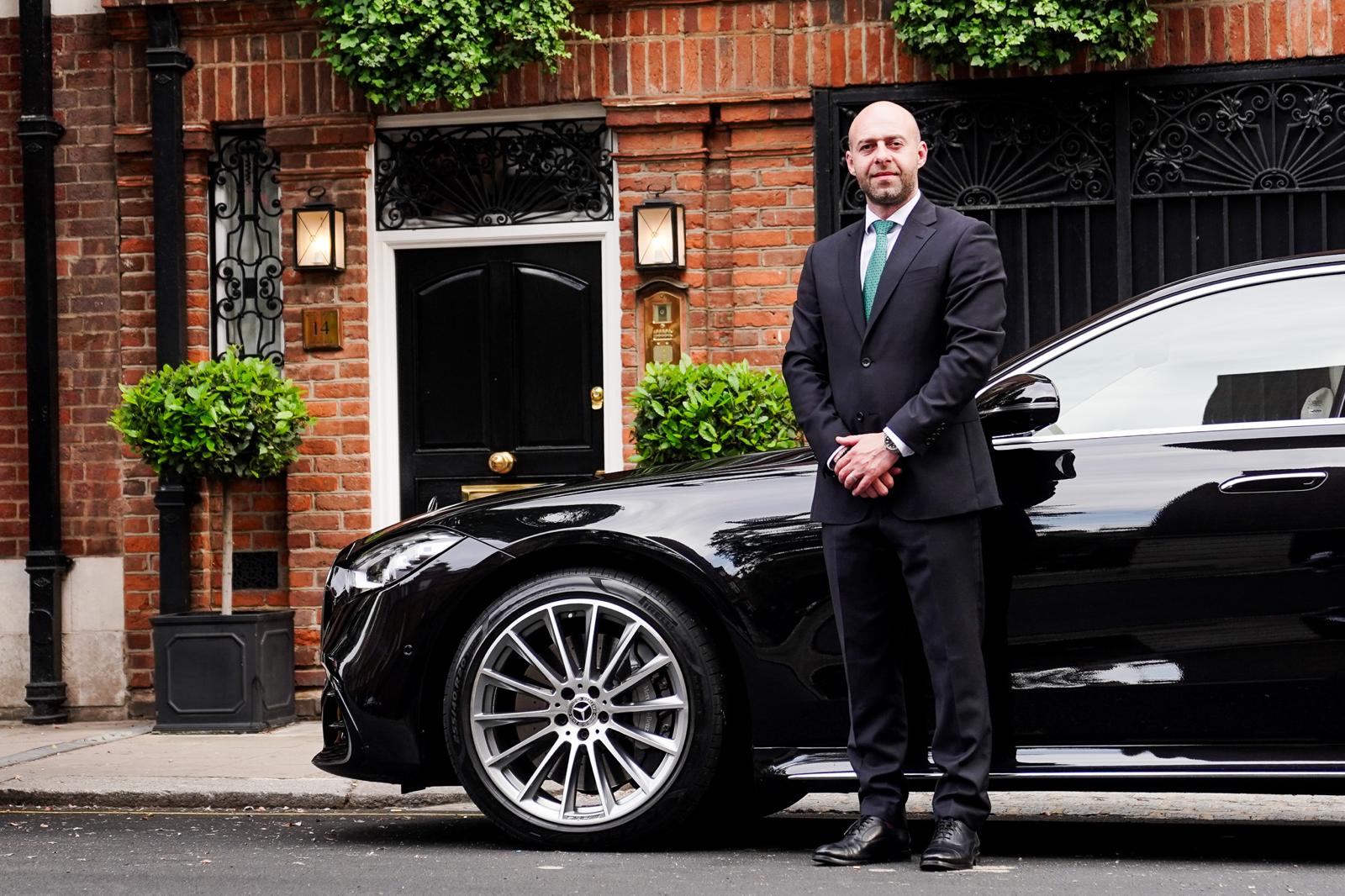 A chauffeur-driven car on a Mayfair street in central London